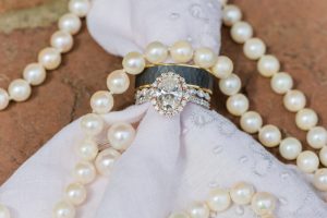 Detail shot of a wedding ring & pearl necklace